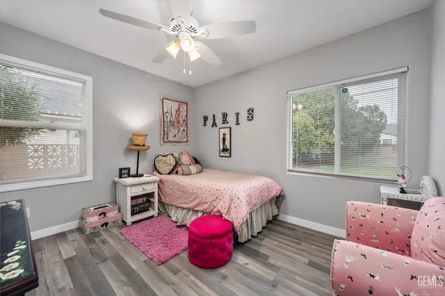 a spacious bedroom with a bed closet and window