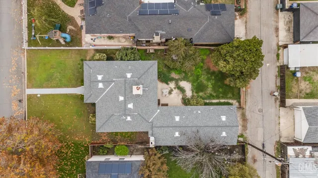 an aerial view of a house with a yard