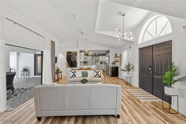 a living room with furniture and a chandelier