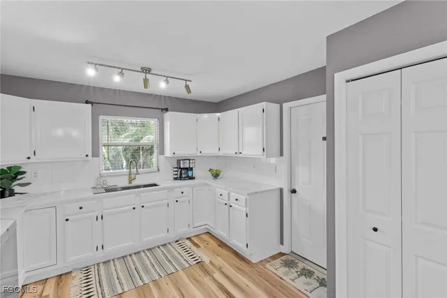 a kitchen with a sink and cabinets