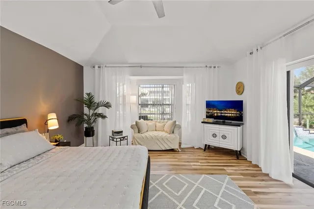 a bedroom with furniture and a flat screen tv