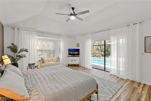 a bedroom with a large bed and a large window