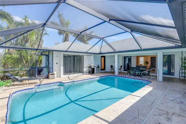a view of a house with swimming pool and sitting area