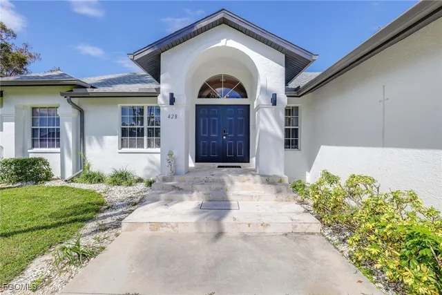 a front view of a house with garden