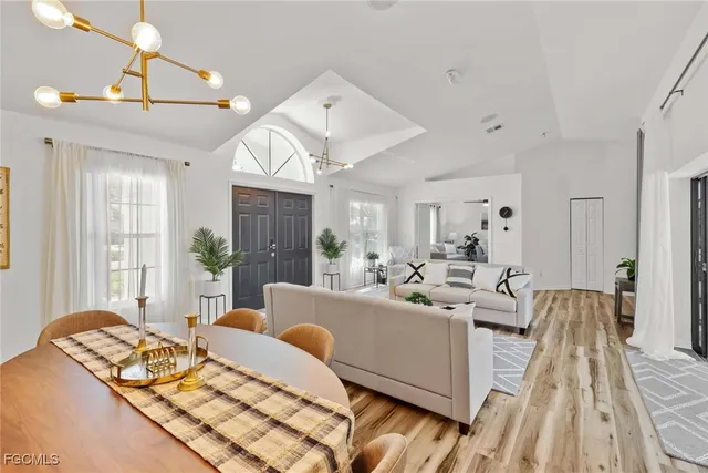 a living room with furniture windows and wooden floor