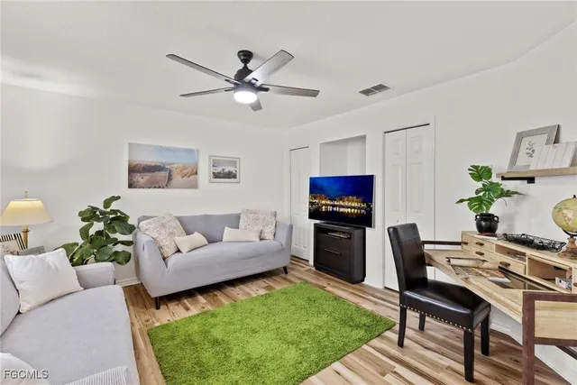 a living room with furniture a rug and a flat screen tv