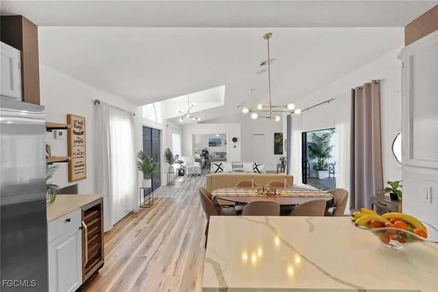 a living room with furniture a chandelier and a flat screen tv