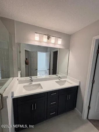 a bathroom with a sink double vanity and a mirror