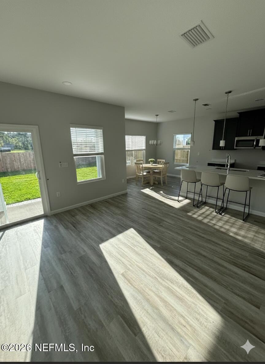 1301 Jewelstone Lane Jacksonville, FL 32221 - Photo 4 of 15 a view of kitchen and empty room with wooden floor