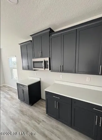 a kitchen with wooden cabinets