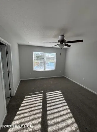 a view of a room with wooden floor and a window