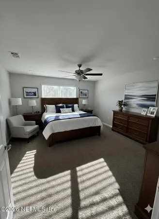 a bedroom with bed and window