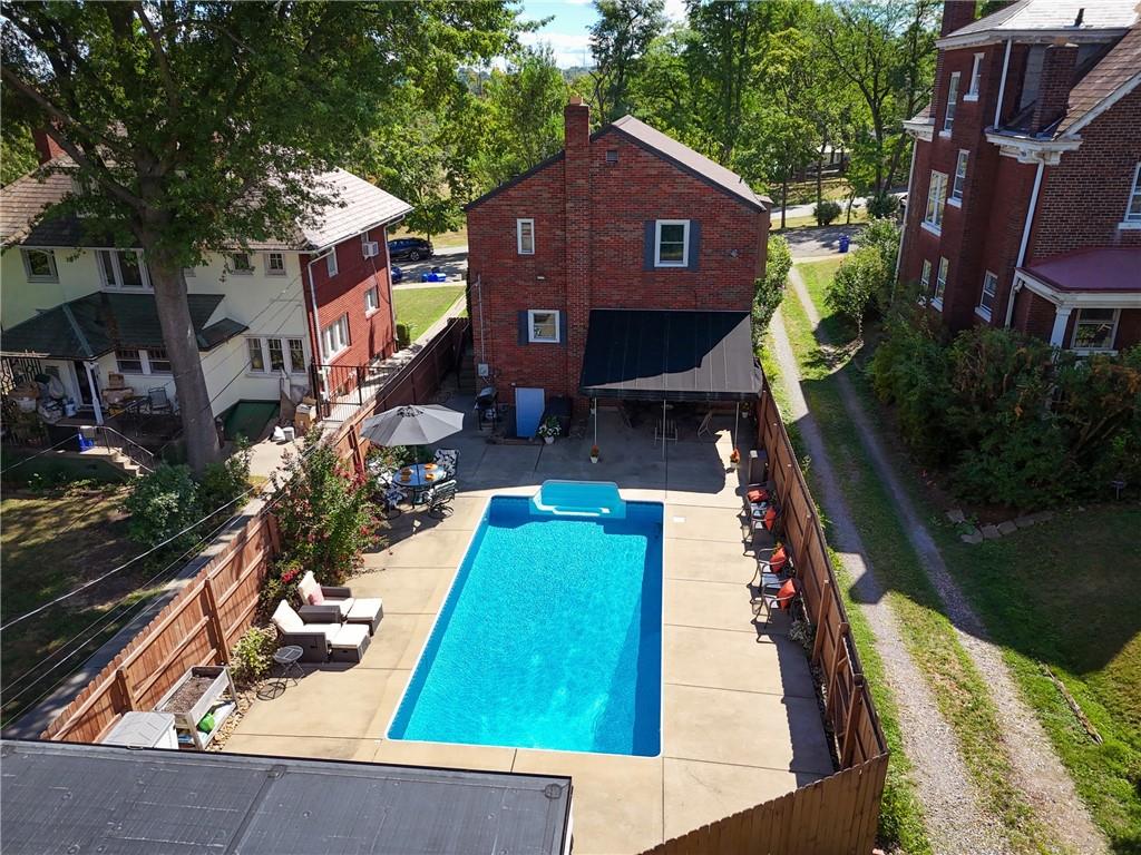 1327 Heberton Street Pittsburgh, PA 15206 - Photo 32 of 40 Back of the home showing the entire pool area, patio, and walk out basement steps