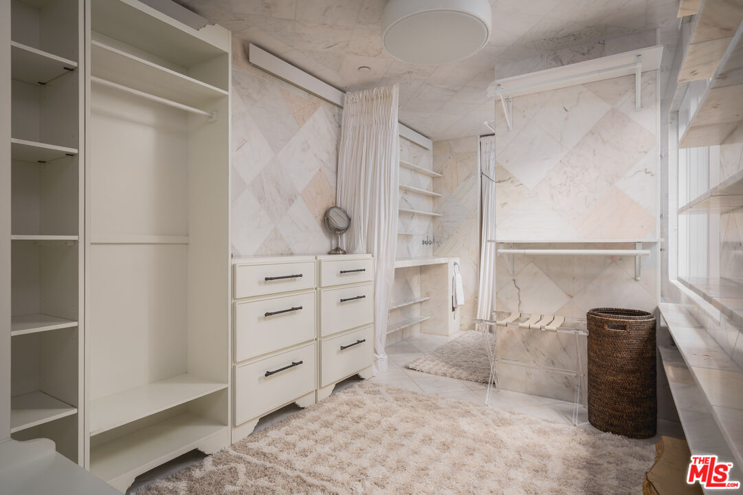 1381 East Valley Road Santa Barbara, CA 93108 - Photo 18 of 28 a view of walk in closet with clothes