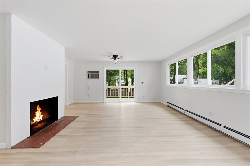 1007 Boston Road Haverhill, MA 01835 - Photo 7 of 32 a view of an empty room with wooden floor and a window