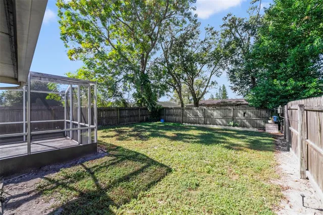 a view of room with window and wooden floor