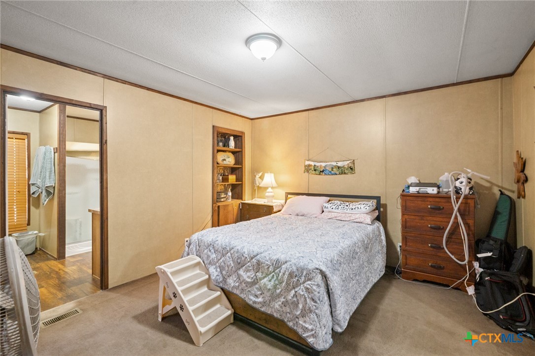 3308 Catalpa Street Victoria, TX 77901 - Photo 19 of 22 a bedroom with a bed a table and chair