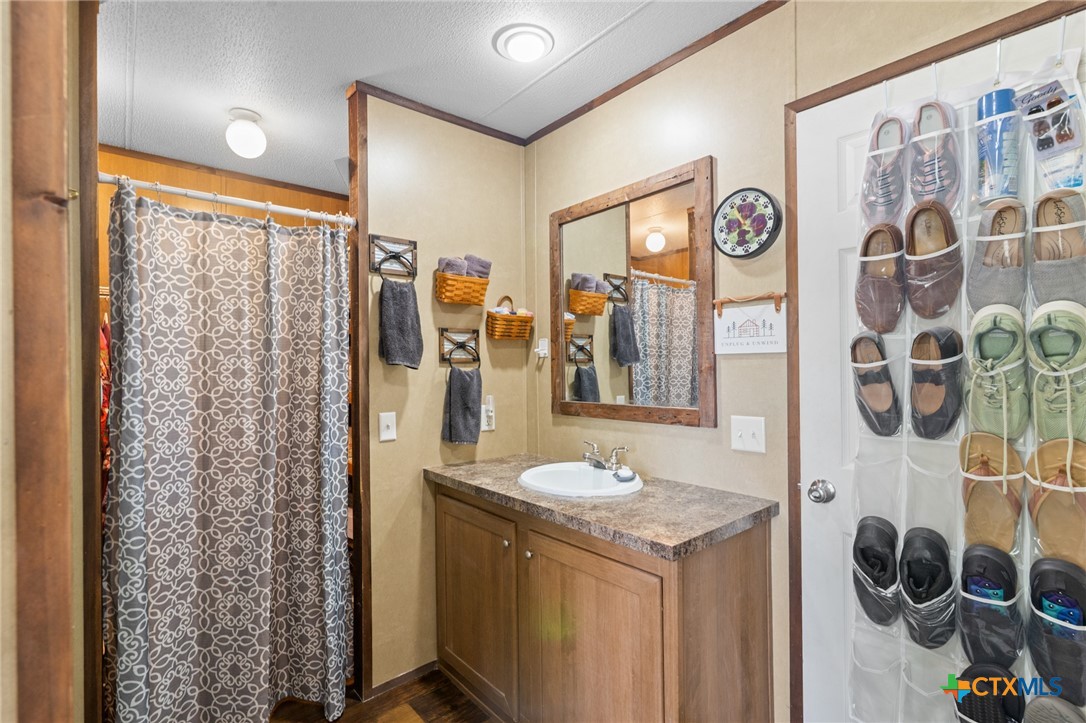 3308 Catalpa Street Victoria, TX 77901 - Photo 22 of 22 a bathroom with a sink and a mirror