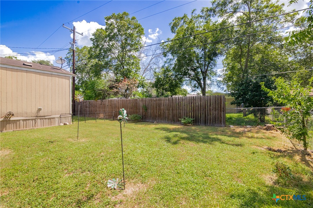 3308 Catalpa Street Victoria, TX 77901 - Photo 6 of 22 a backyard of a house with table and chairs