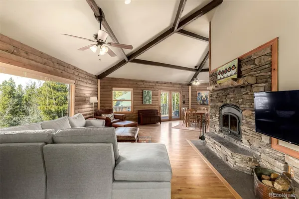 a living room with furniture fireplace and a large window