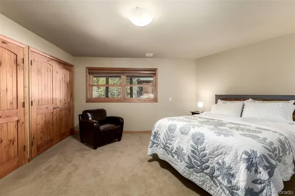 a bedroom with a large bed and a window