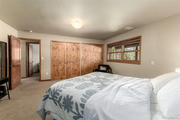 a bedroom with a bed and a couch