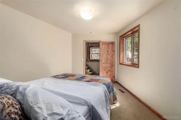 a bedroom with a bed and a window