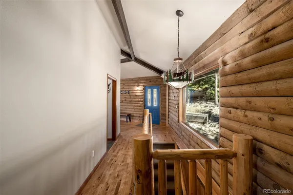a view of a balcony with chair and wooden floor