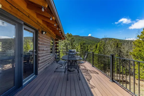 a view of balcony with wooden floor and fence