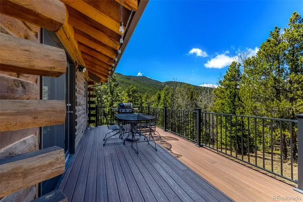 a view of backyard with a deck and wooden floor