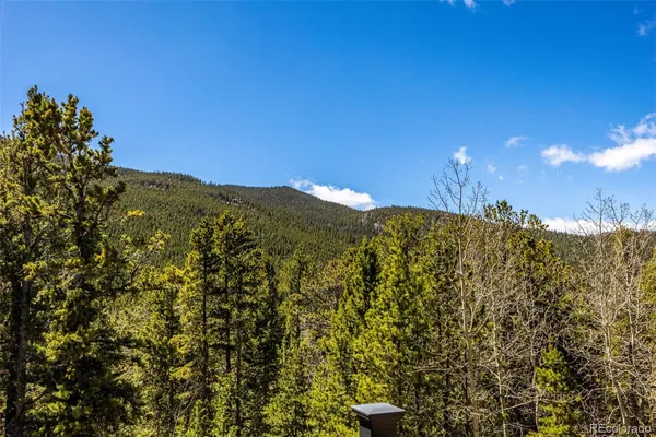 an aerial view of a house with mountain view