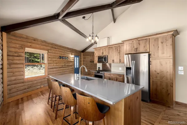 a kitchen with stainless steel appliances a refrigerator stove and cabinets