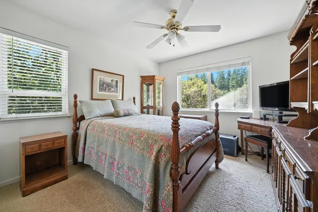 a view of a livingroom with workspace and a window