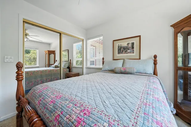 a living room with furniture large window and flat screen tv