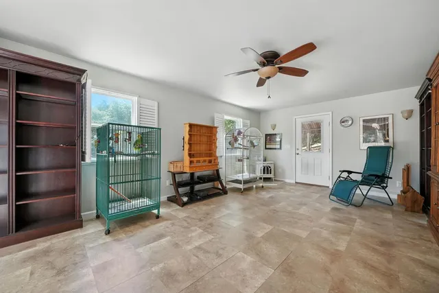 a spacious bathroom with a granite countertop sink and a mirror