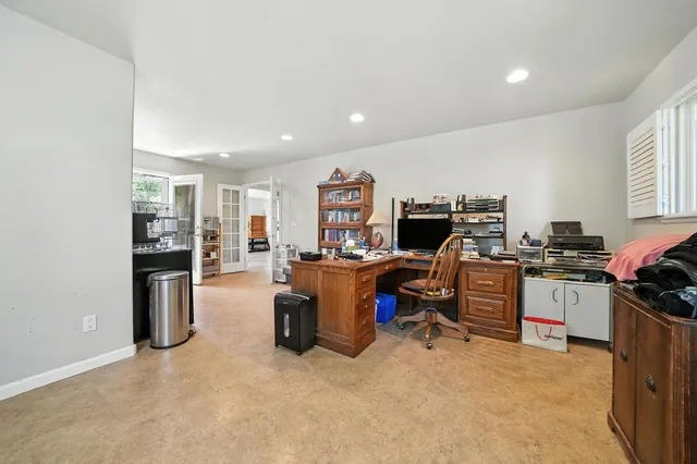 an outdoor sitting area with couch and wooden floor