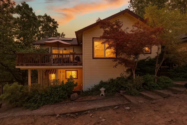 a view of a house with yard and sitting area