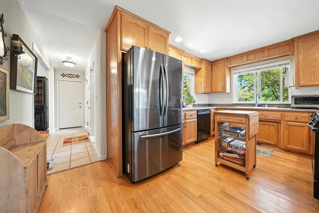 a kitchen with stainless steel appliances granite countertop a sink a stove and a microwave