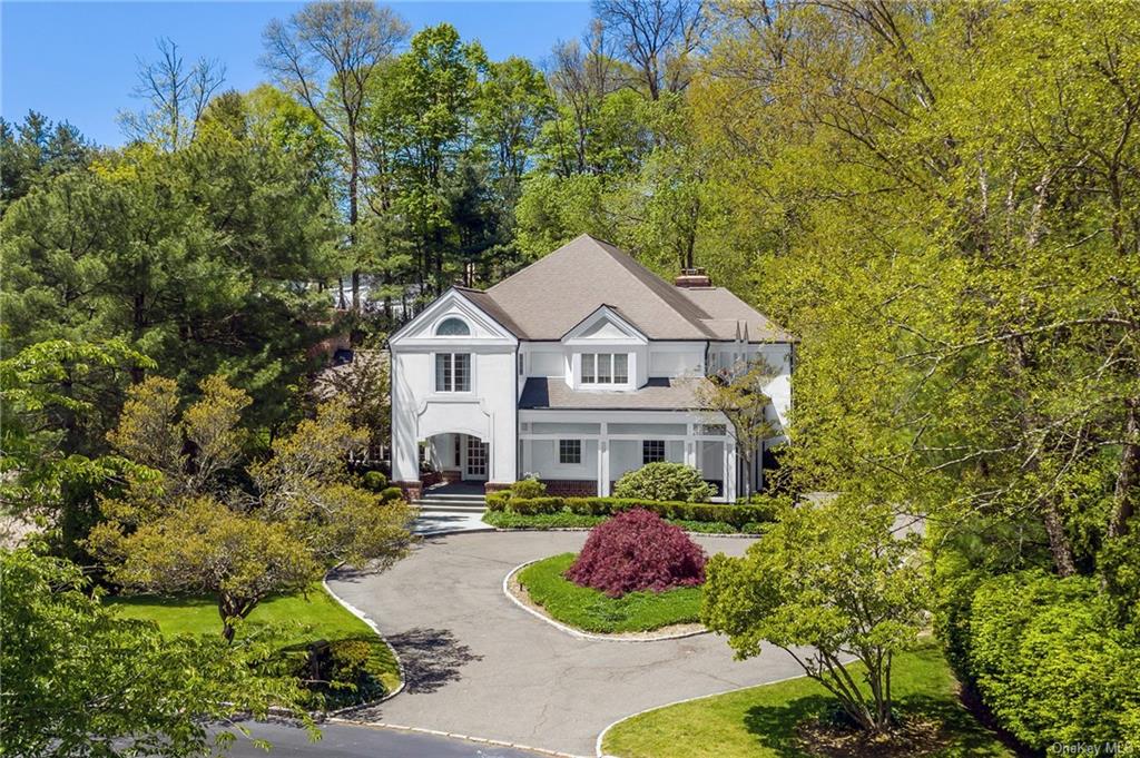 a aerial view of a house with yard and green space
