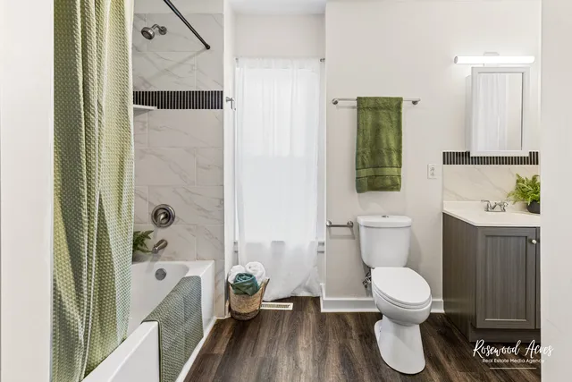 a bathroom with a toilet and a shower