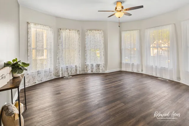 a view of room with window and wooden floor