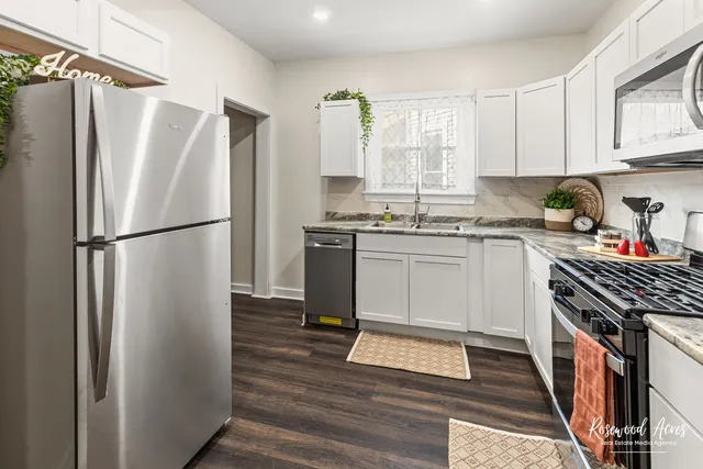 a kitchen with stainless steel appliances granite countertop a refrigerator stove and sink