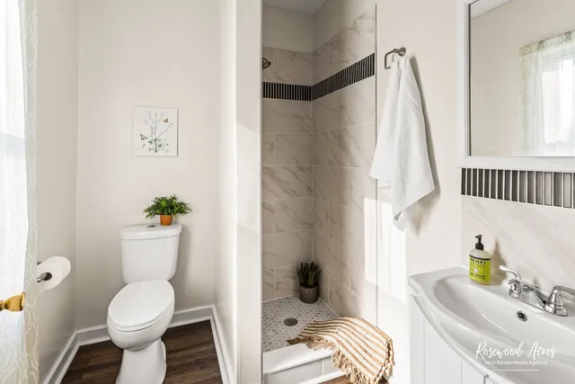 a bathroom with a sink toilet and shower