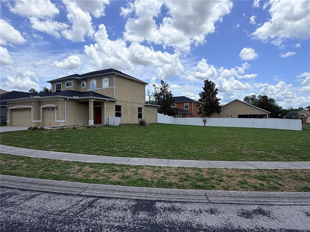 13250 Mandalay Place Spring Hill, FL 34609 - Photo 27 of 28 a front view of a house with a garden