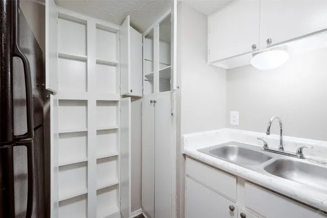 a kitchen with a sink stove and cabinets