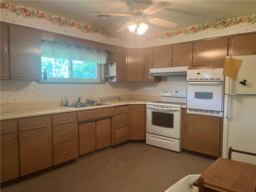 451-457 Joffre Cherry Valley Road Burgettstown, PA 15021 - Photo 9 of 46 a kitchen with cabinets a sink and appliances