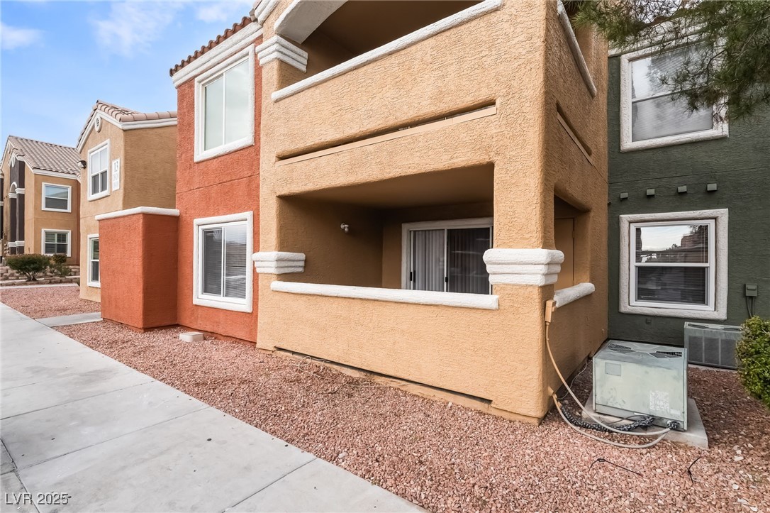 8101 West Flamingo Road, Unit 1090 Las Vegas, NV 89147 - Photo 2 of 30 View of side of property featuring stucco siding and a tile roof