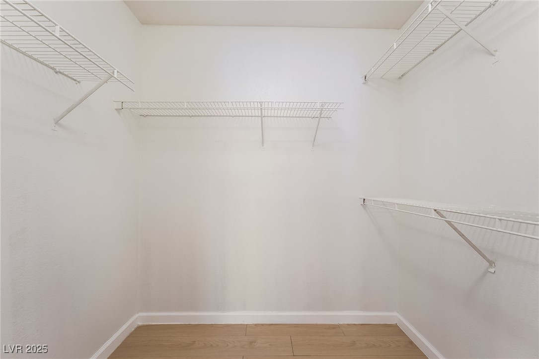 8101 West Flamingo Road, Unit 1090 Las Vegas, NV 89147 - Photo 22 of 30 Spacious closet with light wood-style floors