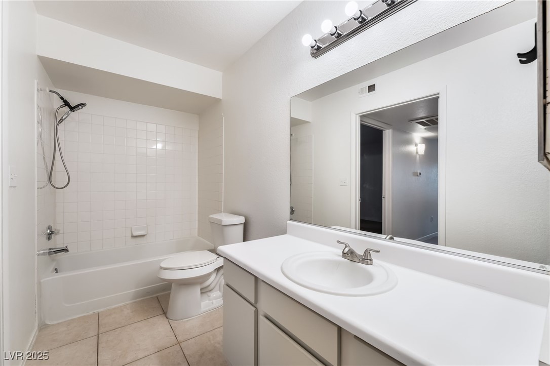 8101 West Flamingo Road, Unit 1090 Las Vegas, NV 89147 - Photo 23 of 30 Full bathroom featuring vanity, bathtub / shower combination, and light tile patterned floors