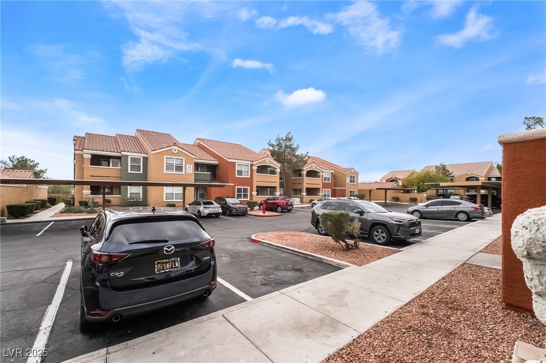 8101 West Flamingo Road, Unit 1090 Las Vegas, NV 89147 - Photo 27 of 30 Uncovered parking lot featuring a residential view